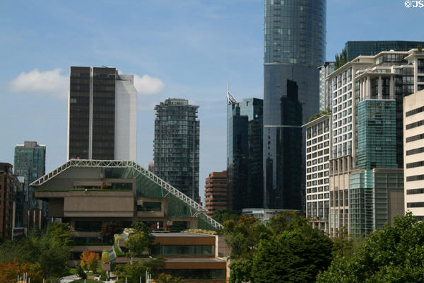 Sloped glass roof of BC Provincial Law Courts with One Wall Centre & other highrises. Vancouver, BC.