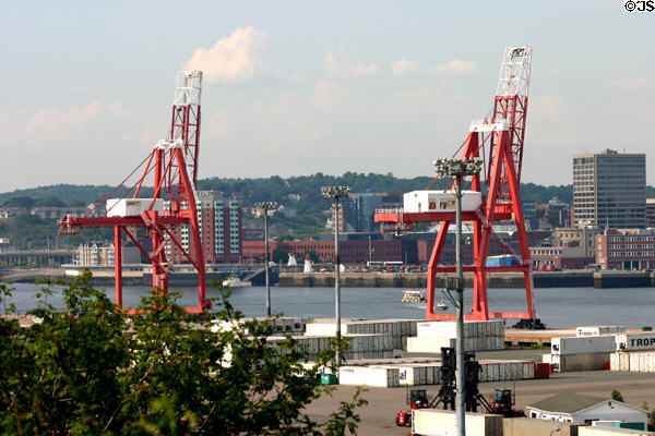 Container port cranes loom over Saint John harbor. Saint John, NB.