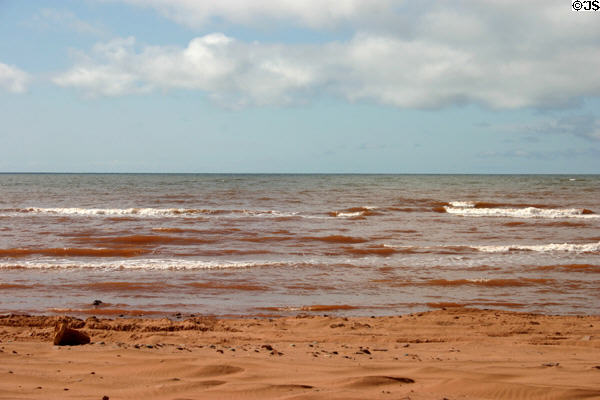 Waves tinted red from the red soil of PEI. PE.