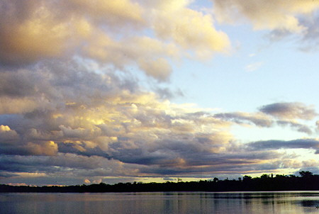 Sun begins to set above Limoncocha Lake in the Amazon basin. Ecuador.