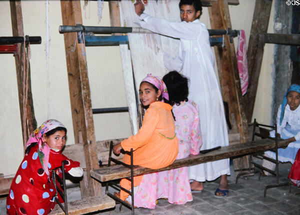 Children weaving carpets in Giza. Egypt.