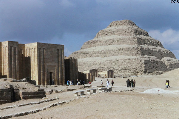 Step Pyramid of Djoser beside remains of enclosure wall which once surrounded the complex. Saqqara, Egypt.