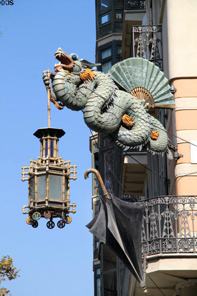 Dragon sculpture holding Chinese lantern & fan over umbrella at Casa Bruno Cuadros on La Rambla. Barcelona, Spain.