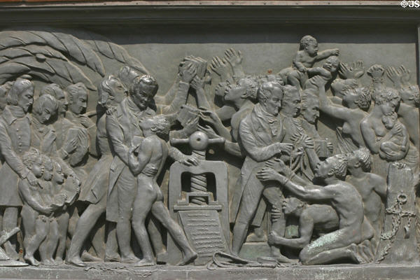 Relief of impact of printing on base of Statue of Guttenberg showing abolition of slavery & writings of Wilberforce, Tomas Clarrion & Condorcet Gregoire. Strasbourg, France.