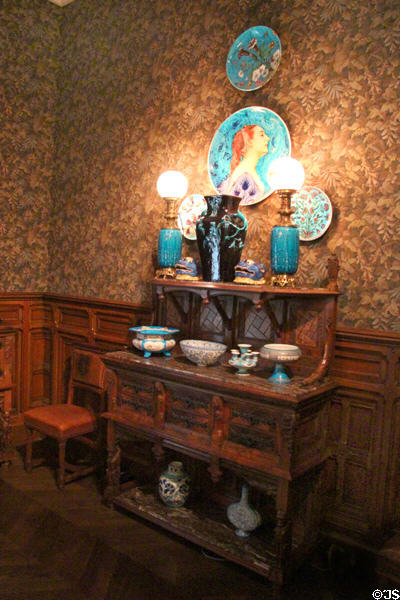 Oak sideboard (1880-5) by Eugène Grasset & cabinetmaker Fulgraff of Paris with oriental-style ceramics at Museum of Decorative Arts. Paris, France.