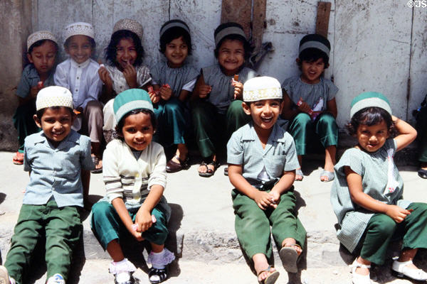 Indian school children smile for camera in old town Mombasa. Kenya.