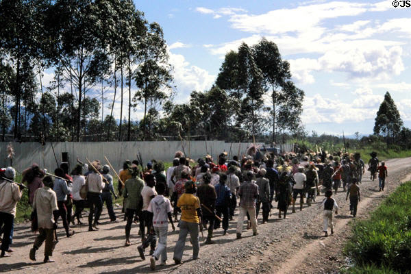 War party armed with spears on road near Banz. Papua New Guinea.