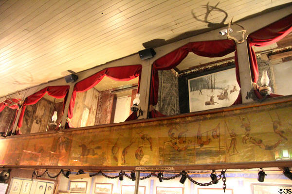 Private boxes with curtains to allow prostitutes to ply trade over circus mural at Bird Cage Theatre. Tombstone, AZ.
