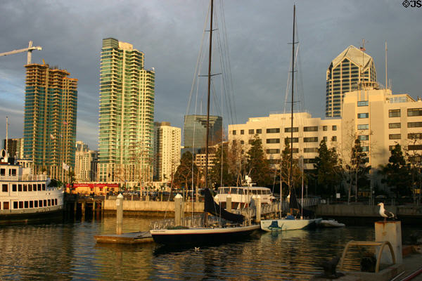 Two green The Grande towers & Naval building from Midway dock. San Diego, CA.