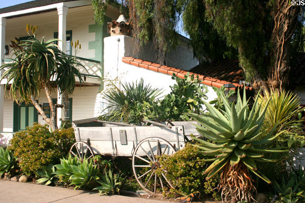 Old wagon & cactus beside Robinson Rose House in Old Town. San Diego, CA.
