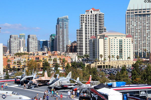 Midway aircraft carrier & aircraft against San Diego skyline. San Diego, CA.
