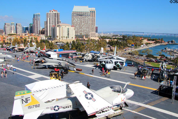 San Diego skyline over Midway aircraft carrier & aircraft. San Diego, CA.