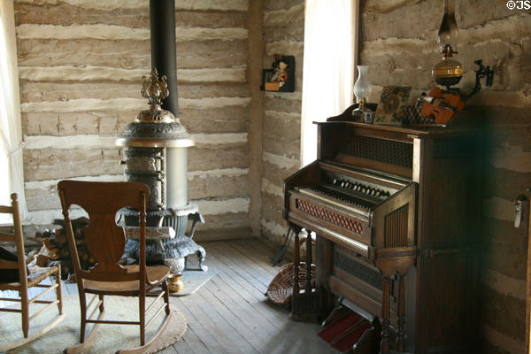 Parlor of settler's log cabin at Clear Creek History Park. Golden, CO.