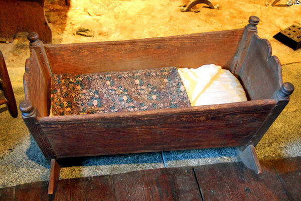 Cradle (late 17thC) with Chintz coverlet at Henry Whitfield State Museum. Guilford, CT.