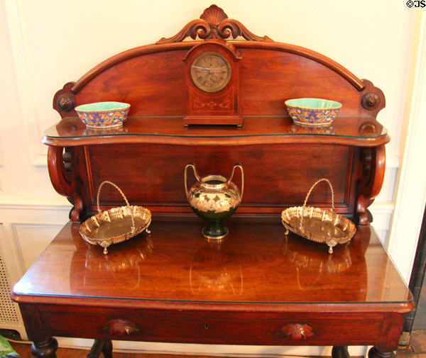 Silver baskets, vase, bowls & clock on side table in dining room at Woodrow Wilson House. Washington, DC.