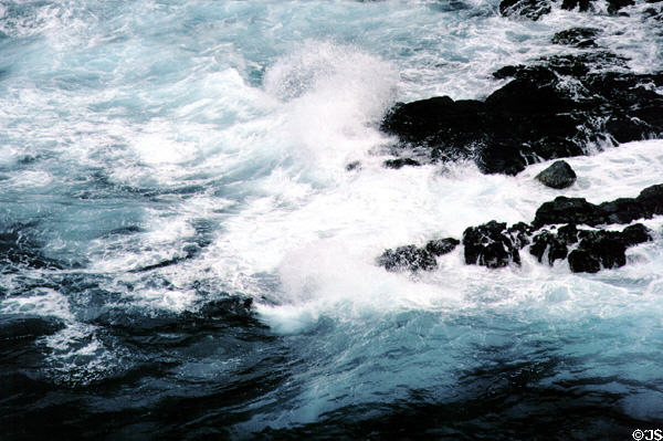 Waves crash against shore near Kilauea Lighthouse. Kauai, HI.