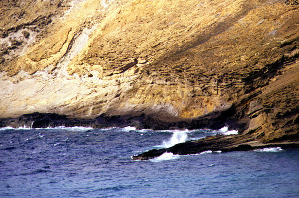 Waves crash against rocks at Hanauma Bay. Oahu, HI.