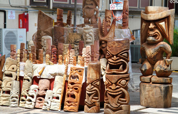Hawaiian tikis & masks in wood carver shop at International Market Place. Waikiki, HI.