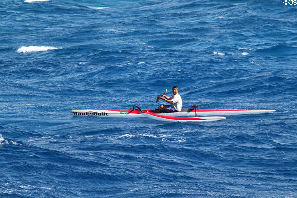 Paddling one-man outrigger off Waikiki Beach. Waikiki, HI.