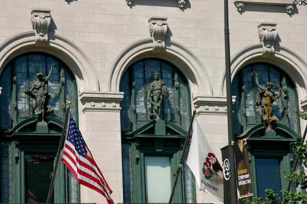 Classical sculptures standing on pediments over portals of School of the Art Institute of Chicago. Chicago, IL.