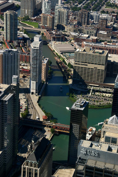Chicago Sun-Times, buildings & commuter trains along North Branch of Chicago River from Sears Tower. Chicago, IL.