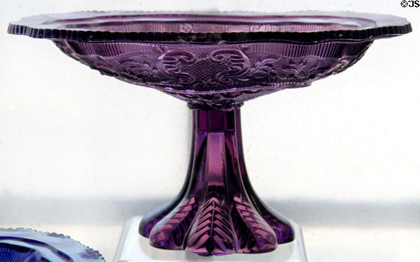 Pressed glass princess-feather medallion design dish on pressed leaf foot (1840-50) by Boston & Sandwich Glass Co. at Sandwich Glass Museum. Sandwich, MA.