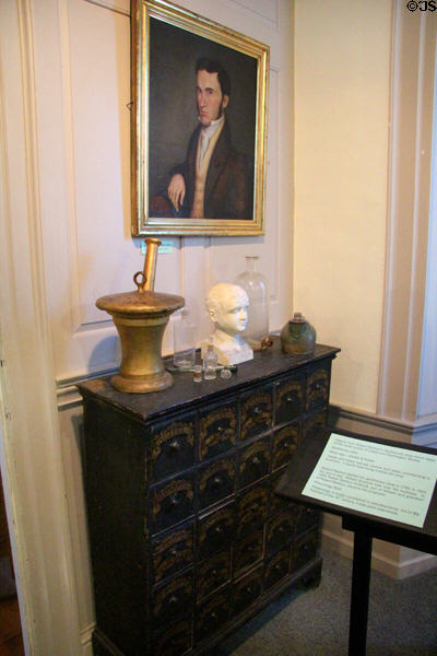 Objects from Robert Rantoul Sr.'s apothecary shop including apothecary case, mortar & pestle shop sign, & phrenology bust at John Cabot House. Beverly, MA.