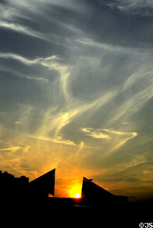 Sun sets between pyramids of National Aquarium. Baltimore, MD.