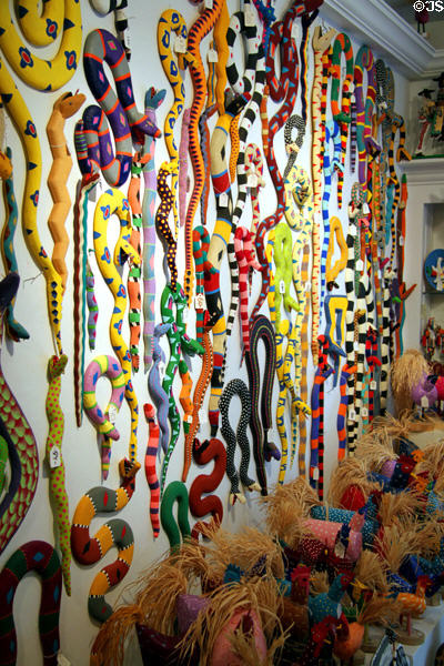 Wall of carved snakes in Davis Mather Folk Art Gallery. Santa Fe, NM.