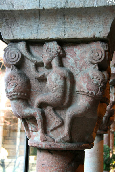Man blowing horn between beasts carved on capital of Cuxa Cloisters at The Cloisters. New York, NY.