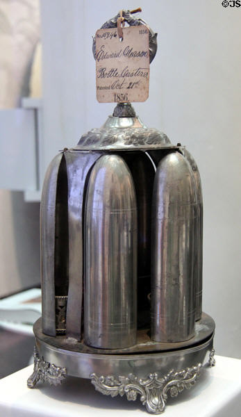 Magic Dinner Caster (c1856) wherein turning a knob reveals condiment bottles by Roswell Gleason & Sons of Dorchester, MA at Brooklyn Museum. Brooklyn, NY.