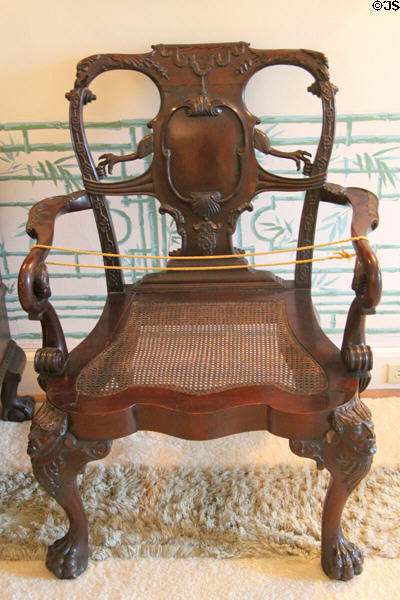 Elaborate antique armchair with caned seat at Chepstow. Newport, RI.