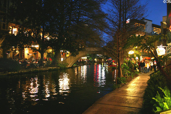 Riverwalk at night with reflections in river. San Antonio, TX.