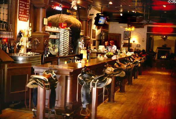 Stockyards Hotel bar with saddles for stools. Fort Worth, TX.