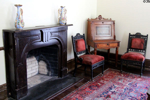 Fireplace with desk & side chairs in Pilot House at Sam Houston Park. Houston, TX.