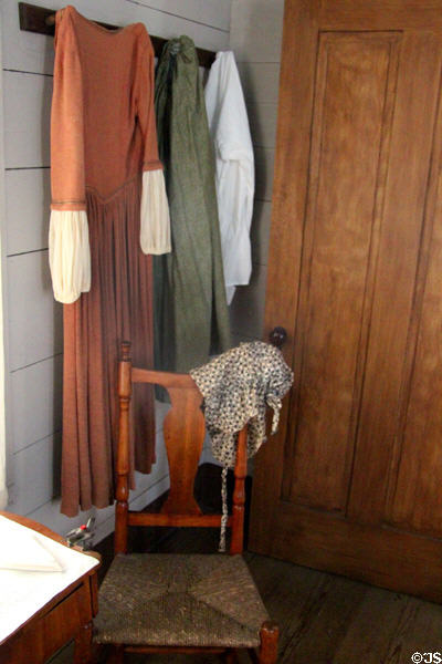 Clothing hung on pegs in Mr. & Mrs. French's bedroom at John Jay French Museum. Beaumont, TX.