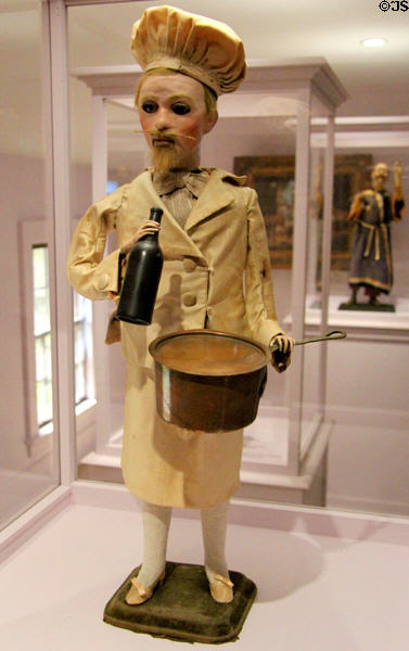 Automaton in form of French Chef which moves bottle to lips while cat pops out of pot (c1885) by Gustave Vichy of France at Shelburne Museum. Shelburne, VT.