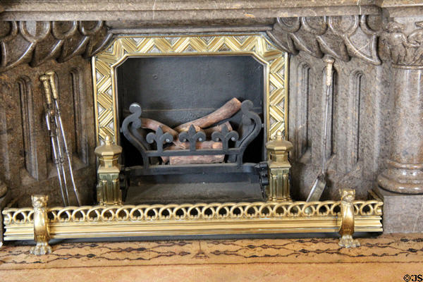 Stone fireplace with zigzag surround in Library at Penrhyn Castle. Bangor, Wales.