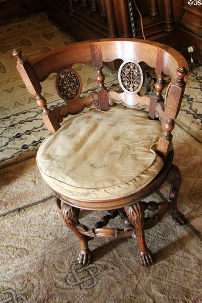 Claw foot carved wooden chair designed by Thomas Hopper in Library at Penrhyn Castle. Bangor, Wales.