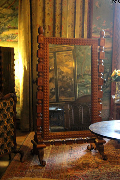 Cheval or dressing mirror mounted in ornate frame in Lower India Room at Penrhyn Castle. Bangor, Wales.