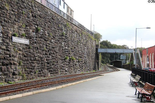 Welsh Highland Railway tracks running in front of station platform. Caernarfon, Wales.