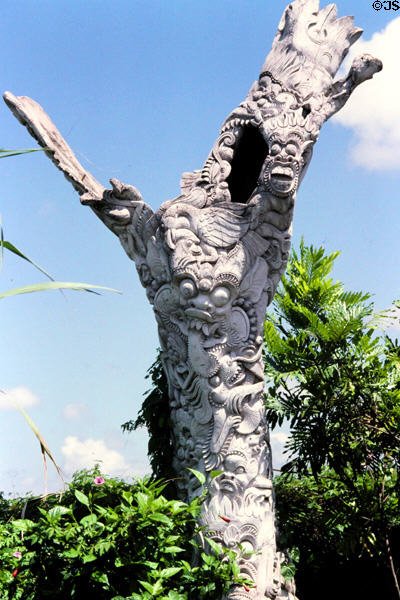 Carvings on a tree stump. Bali, Indonesia.