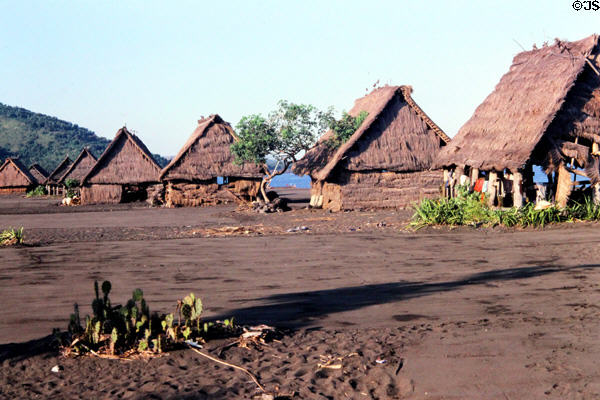 Village of grass huts on beach sand at Kusamba. Bali, Indonesia.