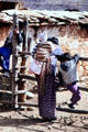 Family resting on a farm fence in Paro. Bhutan.