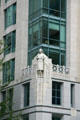 Corner windows & carved nurse on facade of Cathedral Place. Vancouver, BC.