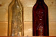 Two antique liquor bottles embossed with fisherman with large fish at Hudson Oddities. NB.
