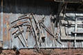 Antique farm tools displayed on side of old barn. Kleinburg, ON.