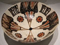 Earthenware bowl with underglaze slip-painting with Arabic word for piety around four points of compass from Khorasan, Iran at Aga Khan Museum. Toronto, ON.