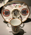Porcelain chocolate beaker & trembleuse saucer tray painted with arms by Du Paquier of Vienna, Austria at Gardiner Museum. Toronto, ON.