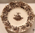 Ironstone plate with brown transfer-print of Canadian beaver ringed by maple leaves by from England at Royal Ontario Museum. Toronto, ON.